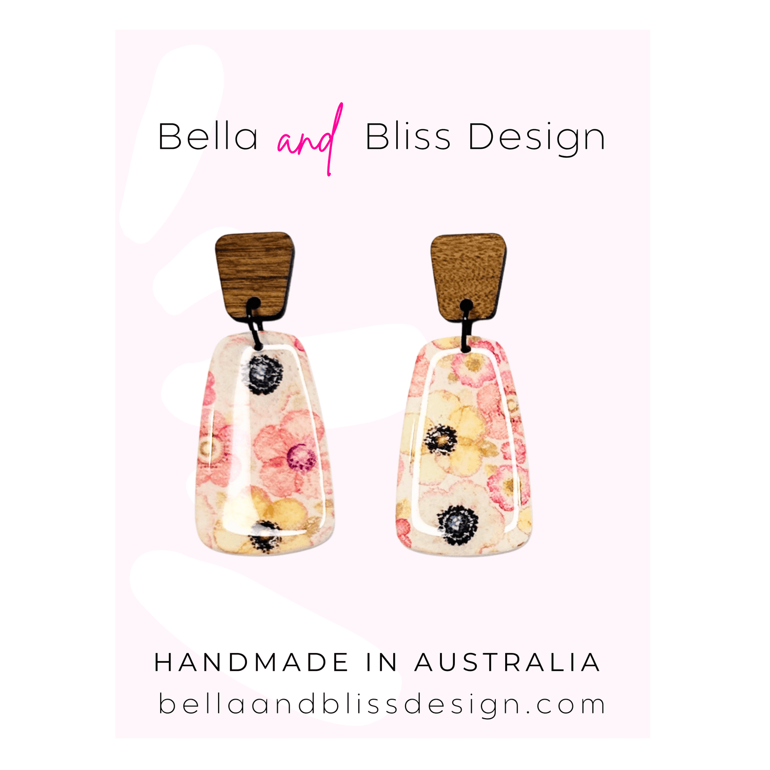 Floral earrings with wooden tops on a light pink background, branded as Bella and Bliss Design.