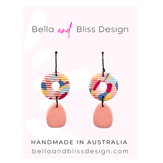 Colorful earrings on a white background with 'Bella and Bliss Design' branding.