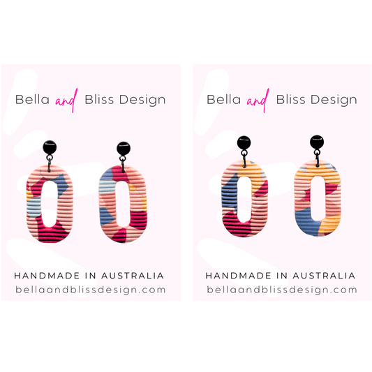 Colorful earrings with 'Bella and Bliss Design' branding on a white background.