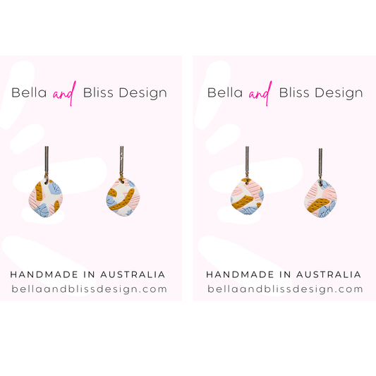 Decorative earrings with geometric patterns on a white background, branded as Bella and Bliss Design.