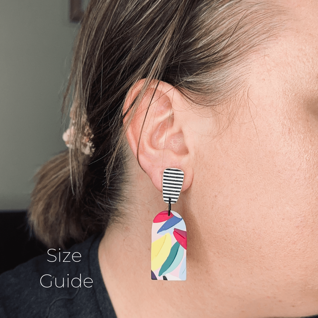 Earring worn by a person with a size guide label