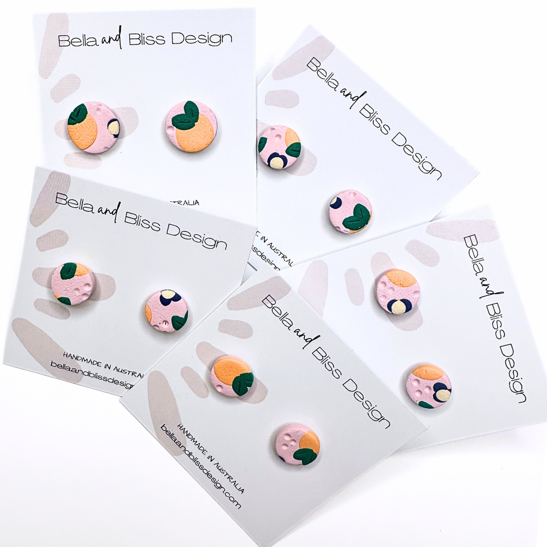 Peach Blossom Earrings with 'Bella and Bliss Design' branding on a pink background