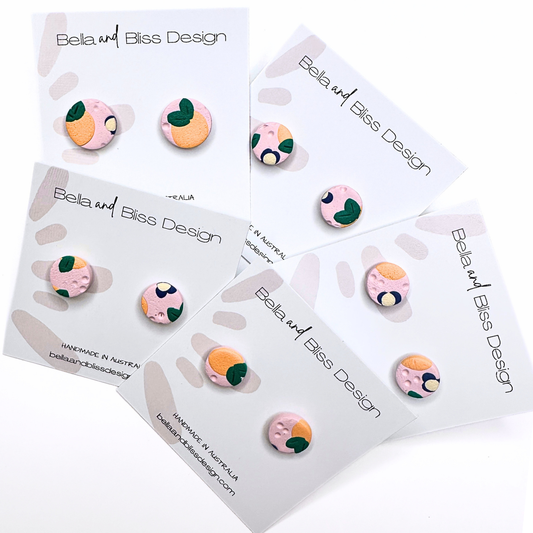 Peach Blossom Earrings with 'Bella and Bliss Design' branding on a pink background