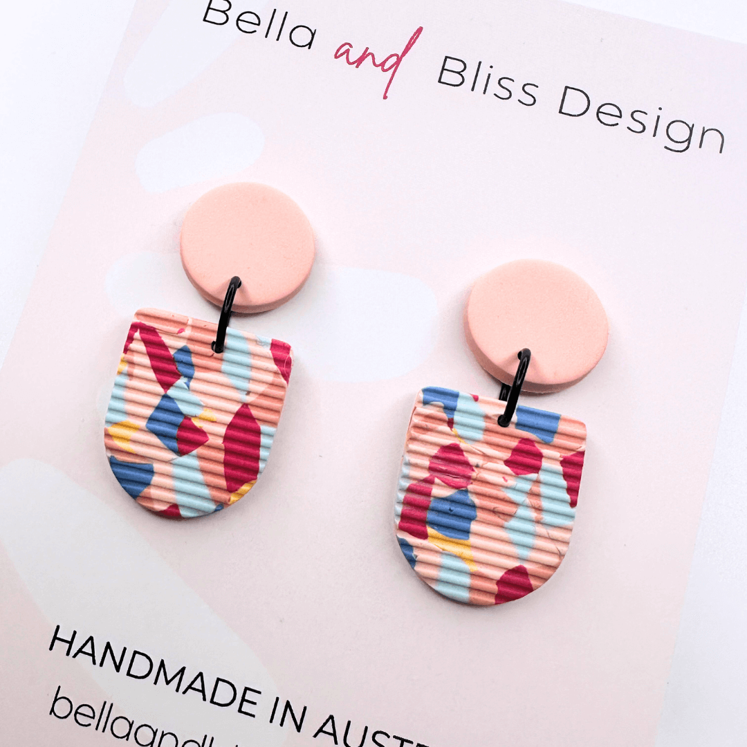 Colourful earrings with 'Bella and Bliss Design' branding on a white background.